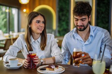 Friends drinking coffee and juice at cafe