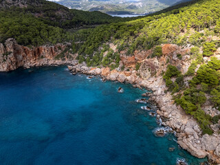 Turquoise blue Mediterranean sea washing rocky shore, Antalya, Turkiye