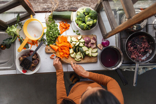 Woman preparing fresh vegetables in Ecuadorian kitchen