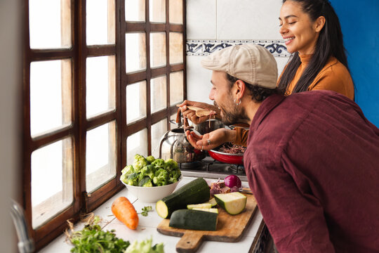 Couple cooking together in a cozy Ecuadorian home