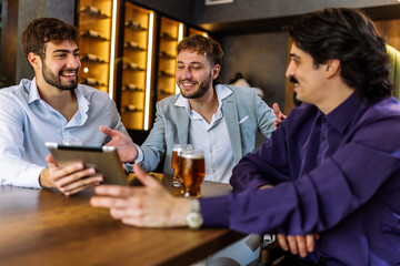 Colleagues discussing work over beer in restaurant