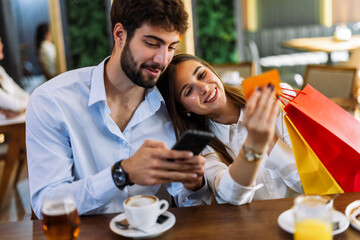 Couple shopping online in restaurant