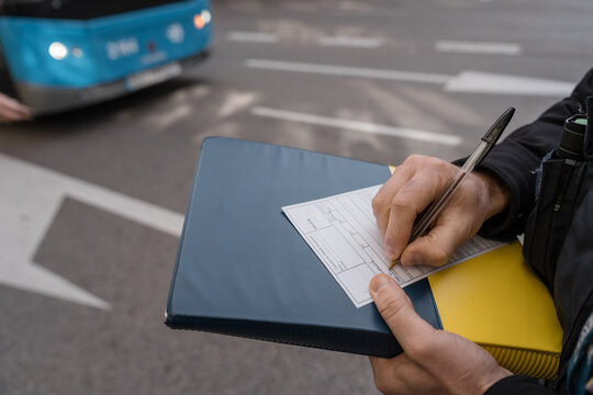Police officer writing a ticket for a public transportation vehicle in madrid