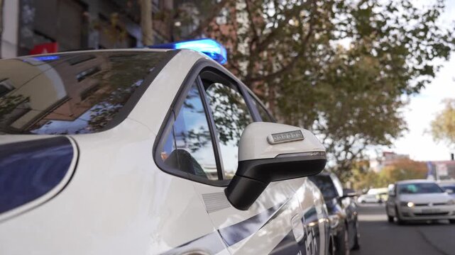 Police car patrolling urban street ensuring public safety