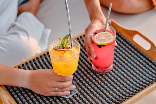 Mother and daughter enjoying drinks by the pool