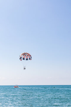 Parasailing adventure over blue ocean under clear sky