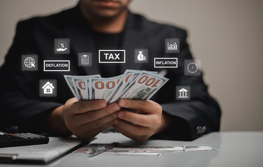 Businessman Holding Cash with Floating Tax and Economic Icons Representing Financial Concepts Like Inflation and Deflation in Modern Economy