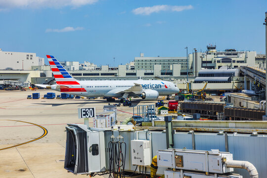 Close up view of American Airlines airplane parked at gate E30 at Miami International Airport on sunny day. Miami. USA.
