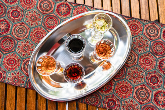 Assorted vodka shots on a silver tray with red pattern