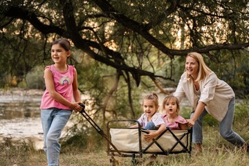Happy family playing together in the park near the river