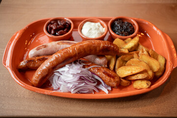 Enjoying grilled sausages and potato wedges in a cozy spot