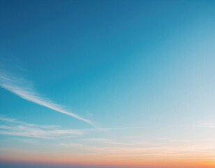 Obraz premium A serene skyscape, showcasing a gradient of colors from a vibrant orange to a clear, bright blue.