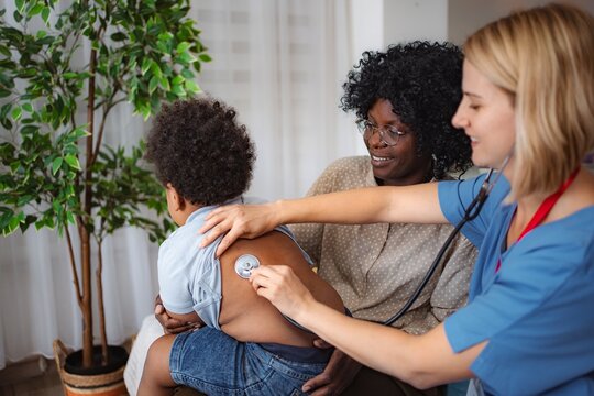 Doctor comforting young child patient