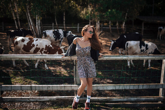Young woman enjoying a sunny day at a peaceful farm park