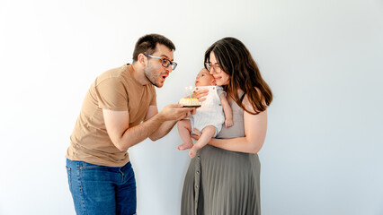 Baby's first cake with parents celebrating together