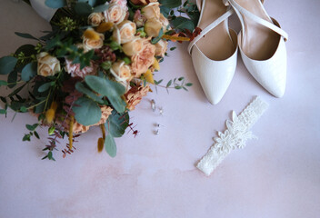 Rings, earrings, bouquet, bridal shoe