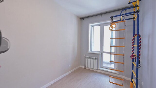 Cozy kids room with an owl wall decal in headphones, a window, radiator, and wooden floors
