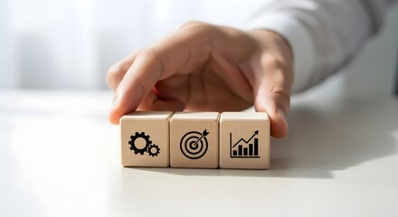 Hand arranging wooden blocks with business icons isolated on white background