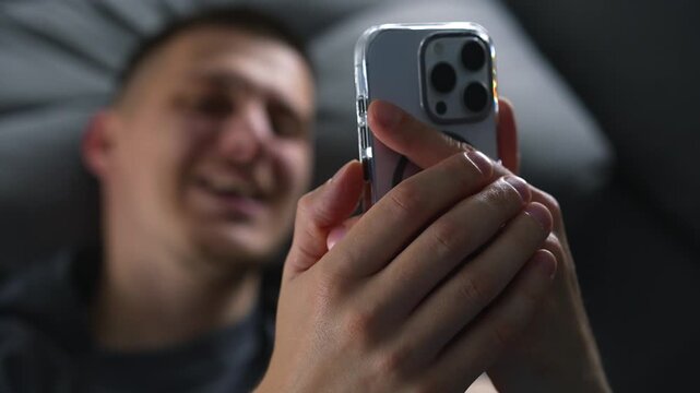 A blogger records a video on a smartphone.
A person lies on a couch and communicates with someone via video call.
Online communication on the internet.
Remote work and freelancing