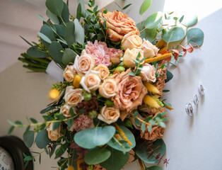 Rings, earrings, bouquet, bridal shoe