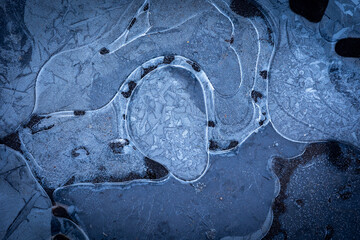 Beautiful ice patterns of a frozen lake. Winter scenery of Latvia.