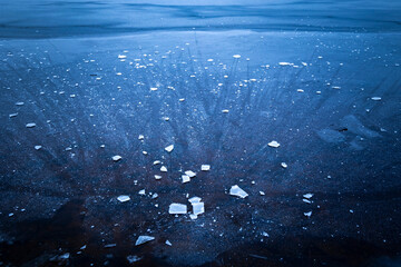 Beautiful ice patterns of a frozen lake. Winter scenery of Latvia.