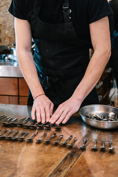 Chef arranging spoons in preparation for cooking