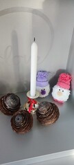 Handmade Christmas decorative candle decorated with three natural pine cones and two cute gnomes.