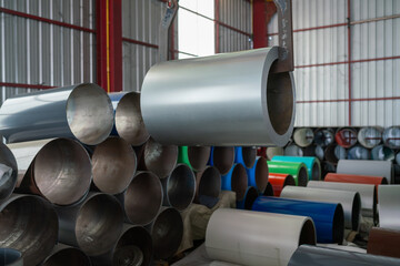 Industrial metal rolling process in a warehouse factory environment close-up view of materials