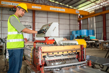 Industrial worker operating machinery in a manufacturing facility workshop environment focused action