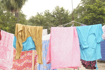 Washing line with drying clothes in outdoor. Clothes hanging on washing line in outdoor.