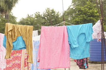 Washing line with drying clothes in outdoor. Clothes hanging on washing line in outdoor.