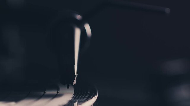 DJ headshell on spinning turntable. Listening music on vinyl. Closeup