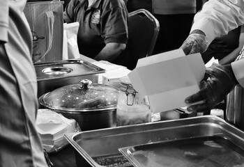 Image of food box being filled with food for sale at an exhibition dated October 11, 2025