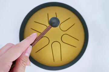 Hand Playing Tongue Drum with Mallet