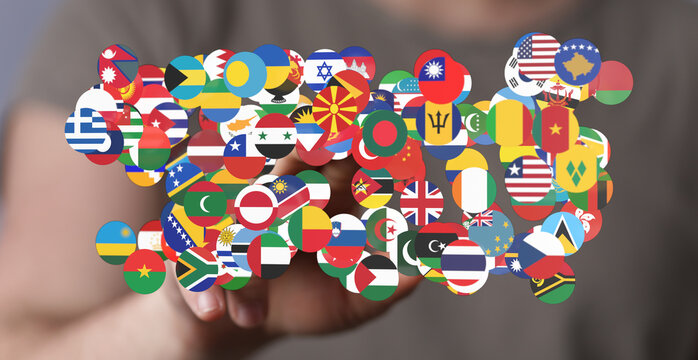 Person's hand reaching for international flags on stickers. Depicting global unity, world peace, and cultural diversity. Perfect for representin
