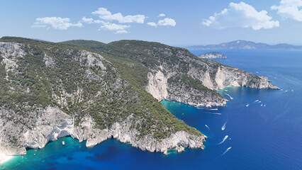 Aerial drone photo of iconic paradise azure caves of Keri forming a blue lagoon visited by small boats and yachts a true summer tourist destination in island of Zakinthos, Ionian, Greece