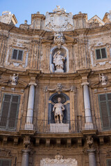 Facade of a building with statues in Piazza dei Quattro Canti in Palermo, Sicily, Italy.