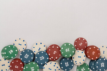 Poker chips and playing cards on color background, top view. Casino card game