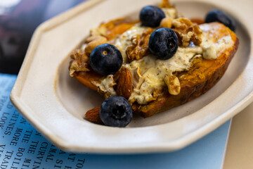 Creative dish with blueberry nut yogurt and roasted sweet potato