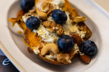 Creative dish with blueberry nut yogurt and roasted sweet potato