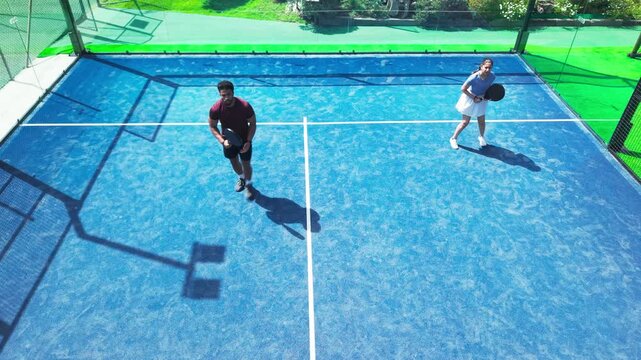 Athlete, people and padel on court for fitness, practice match and high five for contest. Above, friends and celebration for team victory, tennis competition and achievement with winning tournament - Powered by Adobe