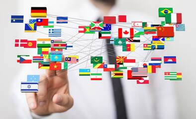 A person interacting with a digital world map featuring flags of various countries, representing global communication and interconnectedness.