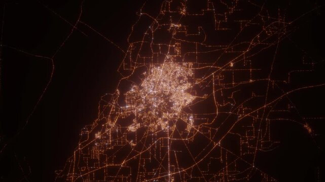 Multan (Pakistan) aerial view at night. Top view on modern city with street lights. Camera is flying above the city, moving backward