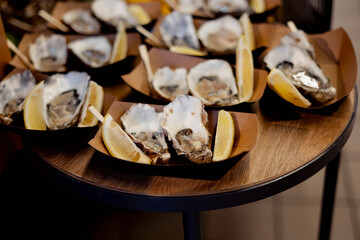 Fresh oysters displayed with lemon wedges