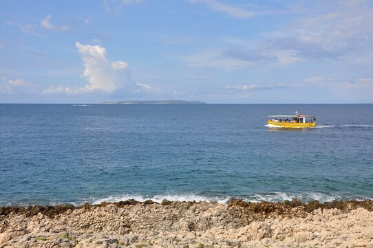 Losinj, Croatia 22 August 2025.Touristic boat with tourists floating in Losinj bay. Adriatic Sea, Losinj Island, Croatia.Motorboat Cruising And Leaving Wake On The Calm Water Of Northern Adriatic Sea.
