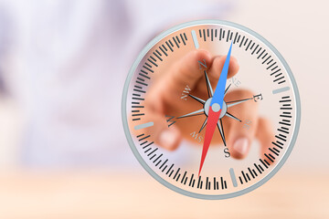 Close-up of a person's hand holding a compass, representing direction, guidance, and navigation....