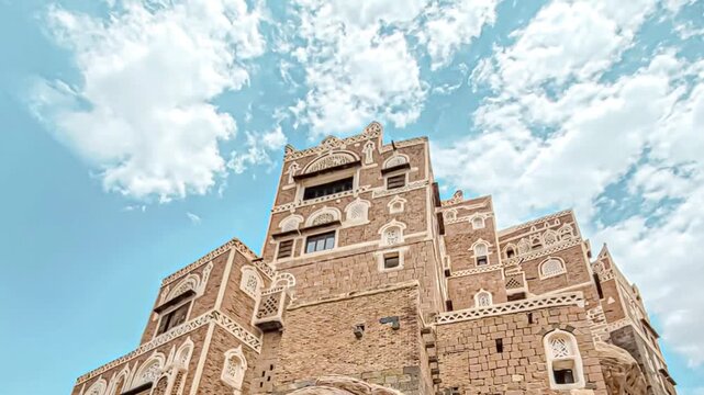 Motion of clouds over Dar Al Hajar ( Stone House ) is a royal palace on a rock located in Wadi Dhahr near Sana&lsquo;a, architecture of Yemen.