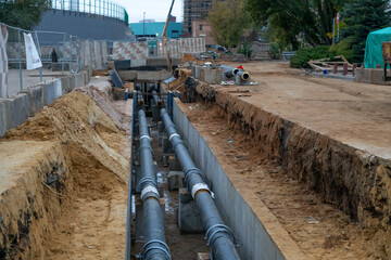 Fototapeta premium Construction site with underground utility work in a city area during autumn