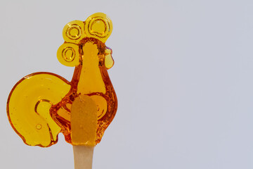 Colorful rooster-shaped candy on a stick showcasing sweet craftsmanship